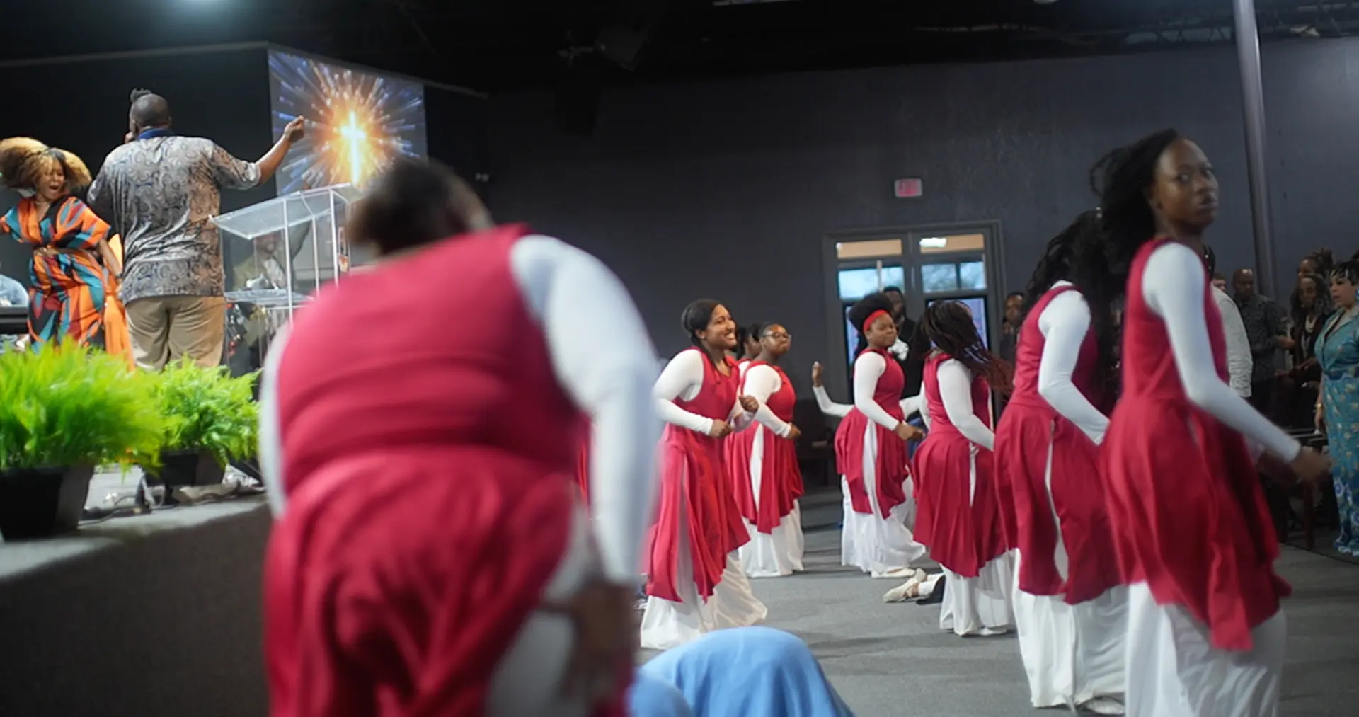 Praise dance team ministering before the pulpit during worship