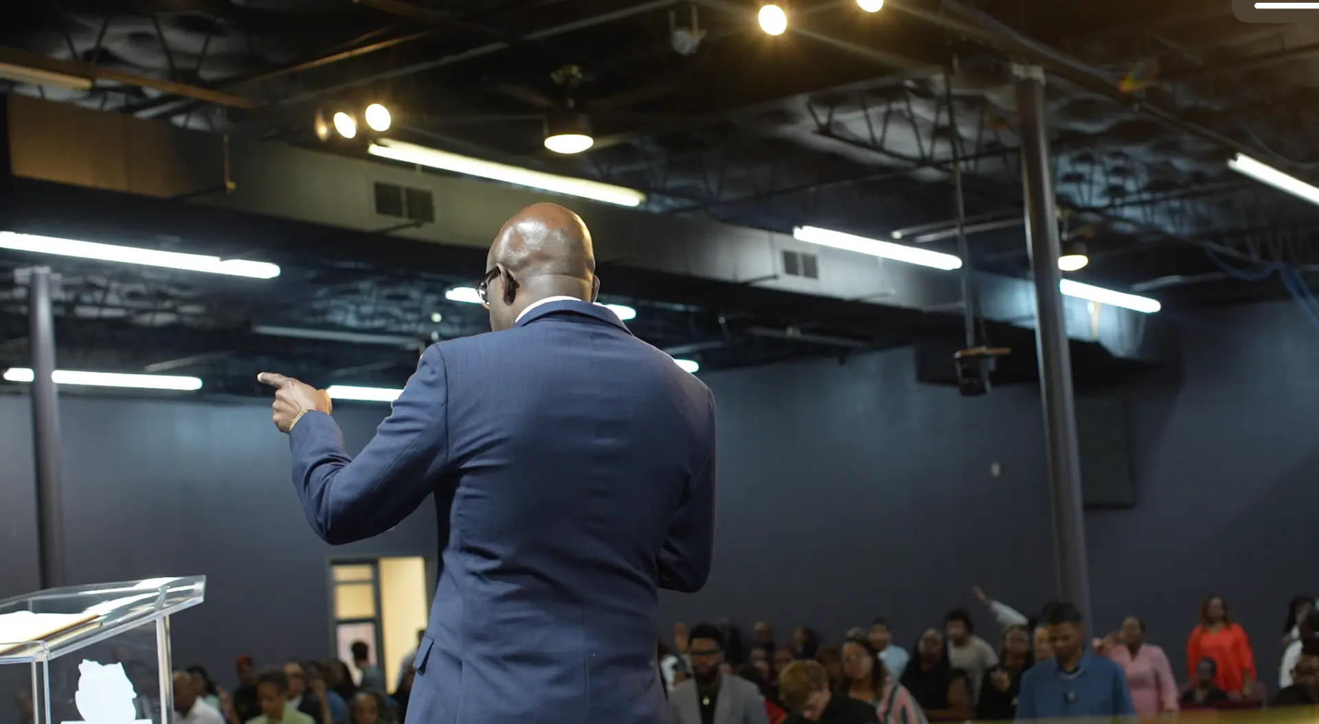 Apostle Frank Manu preaching to a full sanctuary at Word of Peace